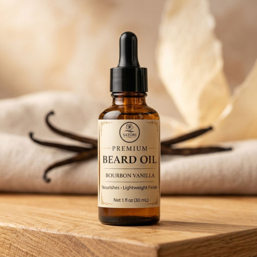 Bottle of premium beard oil with a dropper on a wooden surface, featuring vanilla beans in the background.
